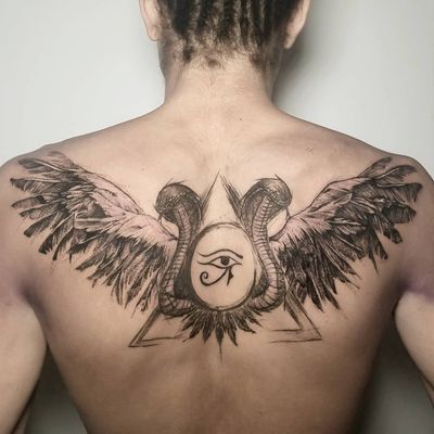 Elegant blackwork tattoo on upper back featuring a snake, wings, eye, and Horus motif by Inkcognito.