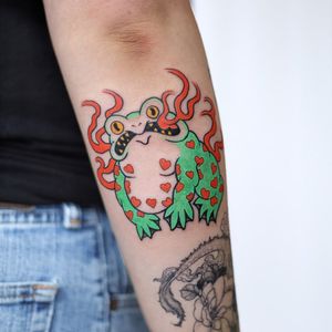 Illustrative tattoo of a frog and heart by Leo Quintao, perfectly placed on the forearm.