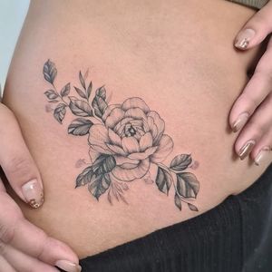 Capture the beauty of nature with a stunning illustrative flower tattoo on your ribs by Liza Vettaa.