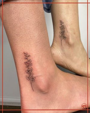 Adorn your ankle with a fine line tattoo of a beautiful flower sprig by the talented artist Tianna, creating a subtle and elegant look.