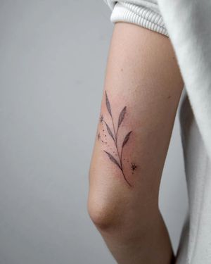 Get a stunning blackwork leaf tattoo on your upper arm by the talented artist Kateryna Tytarenko. Unique and beautiful design.