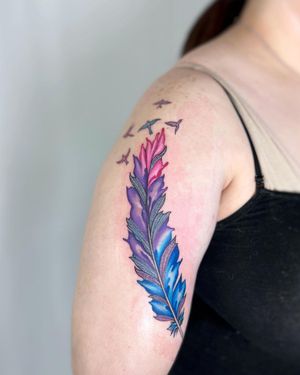 Get a stunning illustrative tattoo of a bird and feather on your upper arm by the talented artist Vic.