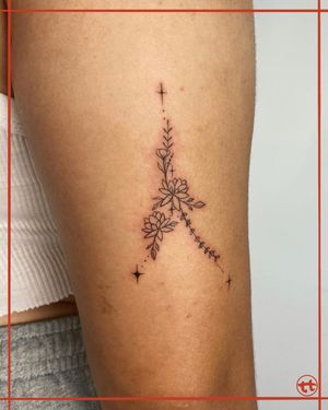 Fine-line arm tattoo featuring a beautifully detailed flower sprig design by Tianna.
