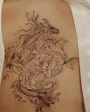 Get inked with a stunning fine line illustration of a dragon intertwined with a delicate flower, by the talented artist Palena.