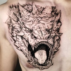 Bold blackwork dragon illustration on chest by talented artist Inkcognito, showcasing fierce and intricate design.