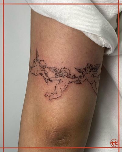 Elegant illustrative angel tattoo on upper arm designed by Tianna, with delicate fine lines and intricate details.