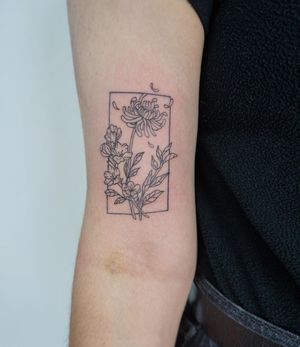 Elegant and delicate upper arm tattoo featuring a beautiful flower design, created in fine line illustrative style by artist Nicole Ksiazek.