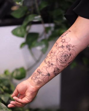 Beautiful blackwork floral design by Sasha Sunshine on forearm, a stunning addition to your ink collection.