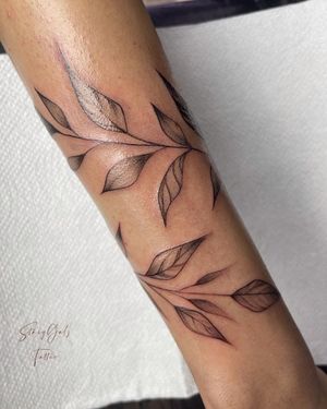 Stunning blackwork tattoo of a leaf designed by Stasy Galz, perfect for arm placement.