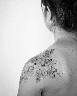Intricate fine line and ornamental design by Sasha Sunshine, featuring a beautiful flower motif on the shoulder.
