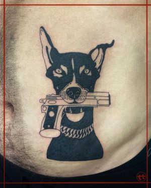Illustrative design by Tianna featuring a dog, gun, and collar, beautifully done in blackwork style on the stomach.