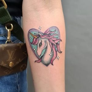 Illustrative forearm tattoo featuring a beautiful combination of a horse, unicorn, and heart by talented artist Liza Vettaa.