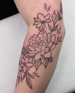 Beautiful blackwork flower tattoo by Stasy Galz on the arm, perfect for a minimalist yet bold statement.
