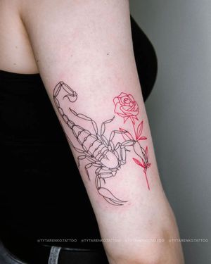 Exquisite upper arm tattoo featuring a detailed scorpion and delicate flower, created by Kateryna Tytarenko.