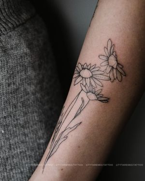 Express your love for nature with this stunning blackwork flower tattoo on your forearm by Kateryna Tytarenko.