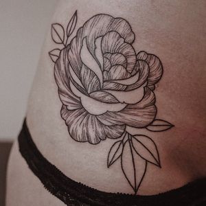 Experience Juli Liverinova's blackwork style with this intricate and delicate flower design on your ribs.