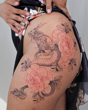 Capture the beauty of a dragon and delicate flower in Sasha Sunshine's illustrative blackwork style on your upper leg.