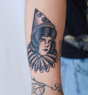 Unique blackwork and traditional design by Jenna Jeep, featuring a clown woman with a hat on the arm.