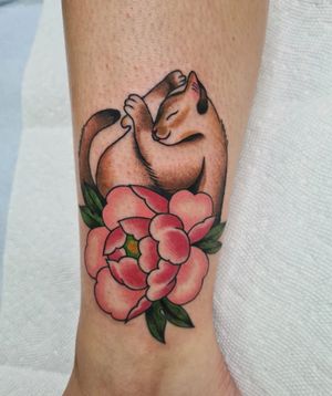 Get inked with a stylish neo-traditional cat and flower design on your ankle by the talented artist Liza Vettaa.