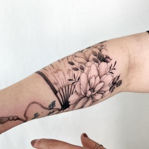 Unique blackwork tattoo of a beautiful flower designed by Yasmin Clara, perfect for the forearm.