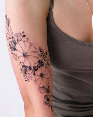 Stunning blackwork flower tattoo for your upper arm, designed by the talented Sasha Sunshine.