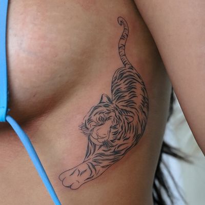 Get a fierce and detailed tiger tattoo on your ribs by the talented artist Kateryna Tytarenko. A stunning and bold choice for your next ink!