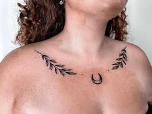 Beautiful blackwork and illustrative design by Jenna Jeep combining a crescent moon and delicate leaf motif on the chest.