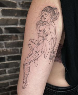 Fine line and illustrative tattoo on upper arm by Palena, featuring a strong girl with sword and armor.