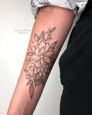 A stunning blackwork tattoo of a flower on the forearm by the talented artist Stasy Galz.