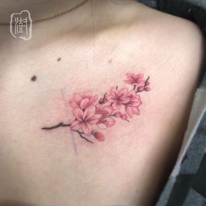 Get a stunning illustrative watercolor flower tattoo on your chest from the talented artist Cerf. Embrace the beauty of nature with this unique design.