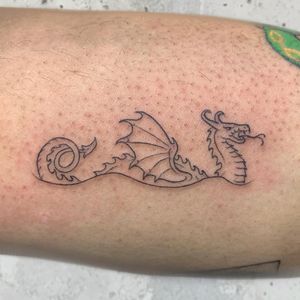 Elegant fine line and illustrative style dragon tattoo beautifully crafted by the talented artist Holly Hawk.