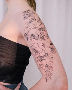 Blackwork flower tattoo on arm by Sasha Sunshine, beautifully detailed and stunningly unique.