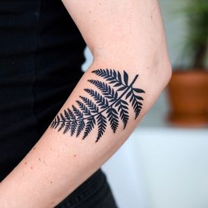 Bold blackwork design by Jenna Jeep, showcasing a detailed leaf motif on your forearm.