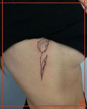 Discover the beauty of fine line and illustrative style with this stunning flower tattoo by Tianna, perfect for the ribs.