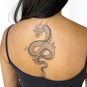 Get a stunning illustrative dragon tattoo on your upper back by the talented artist Leo Quintao. Perfect blend of fine lines and intricate details.