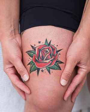 A traditional style flower tattoo on the upper leg, expertly executed by artist Steven Brooks.