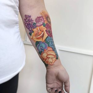 Experience the beauty of nature with this stunning realistic flower tattoo on your forearm. Expertly done by tattoo artist Daniel Verdysh.