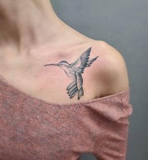 Get exquisite illustrative bird tattoo by Liza Vettaa on your shoulder. Embrace the beauty and grace of a hummingbird with fine line style.