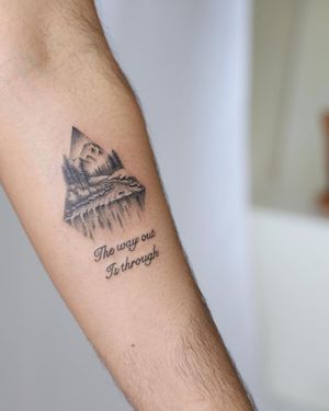 Beautiful blackwork forearm tattoo featuring a mountain and tree illustrative design with meaningful quote by Cerf.