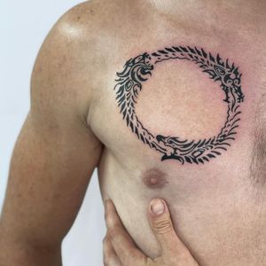 Explore the eternal cycle of life and death with this mesmerizing blackwork ouroboros design by Nicole Ksiazek.