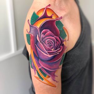 A stunning illustrative flower tattoo on the upper arm, expertly done by tattoo artist Daniel Verdysh.