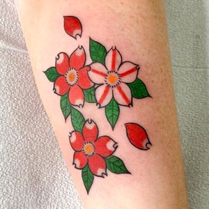 Get this stunning cherry blossom tattoo by artist Leo Quintao for a beautiful and elegant arm piece. Perfect for nature lovers!