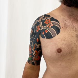 Experience the beauty of nature with this illustrative cherry blossom tattoo by Leo Quintao. Perfect for chest placement.