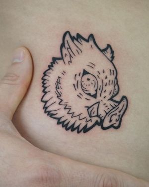 Unique chest tattoo featuring a blackwork illustrative pig design, created by artist Nicole Ksiazek.