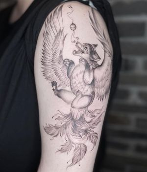 Get inked with a striking blackwork tattoo of a dog with wings on your upper arm by the talented artist Palena.
