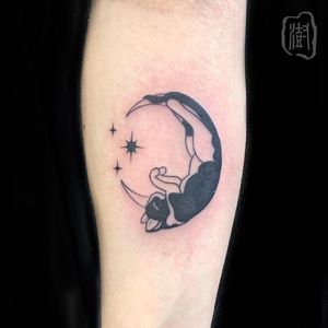 Elegant blackwork forearm tattoo of a mystical moon and cat design by Cerf. Perfect for those who embrace the night.