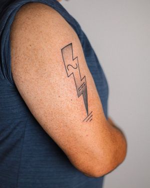 Get electrified with this illustrative tattoo by Steven Brooks featuring a unique patterned lightning motif on your upper arm.