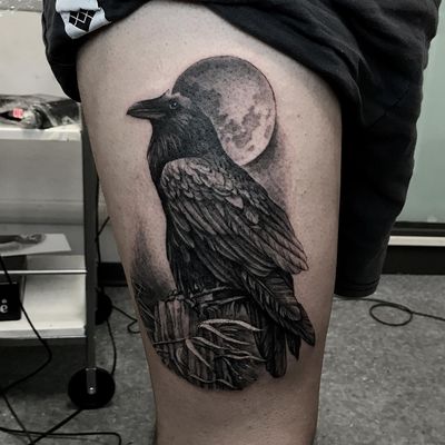 Bold blackwork tattoo featuring a mystical raven and crescent moon, beautifully illustrated by Juli Liverinova.