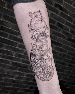 Get a unique blackwork tattoo on your forearm by Palena featuring a bird, fruit, and squirrel. Stand out with this intricate design!