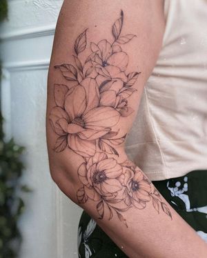 Get an elegant and detailed flower tattoo on your arm with fine line and illustrative style by the talented artist Irene Bogachuk.